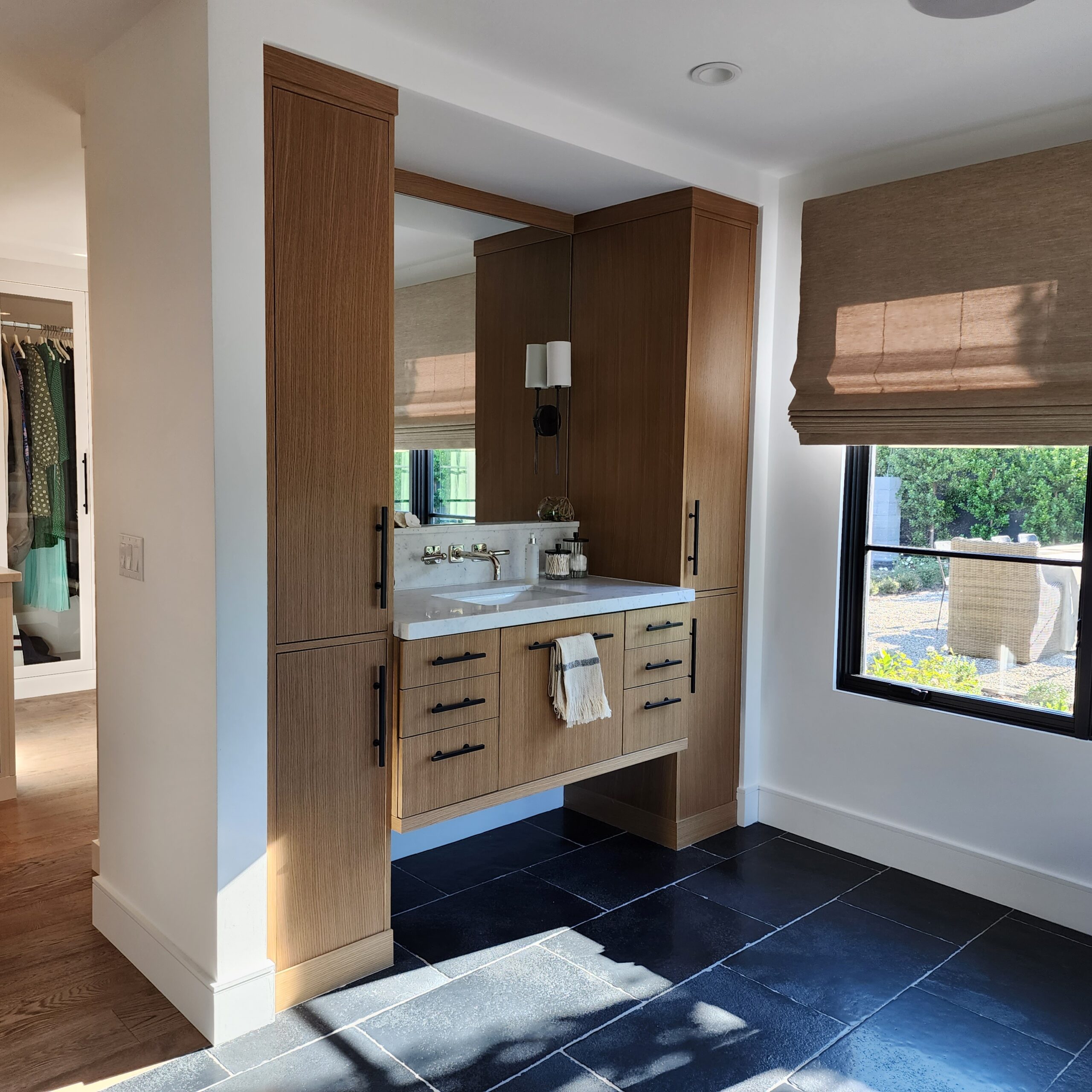 Master bath with floating sink base and tall linen cabinets — Westgate Woodworks